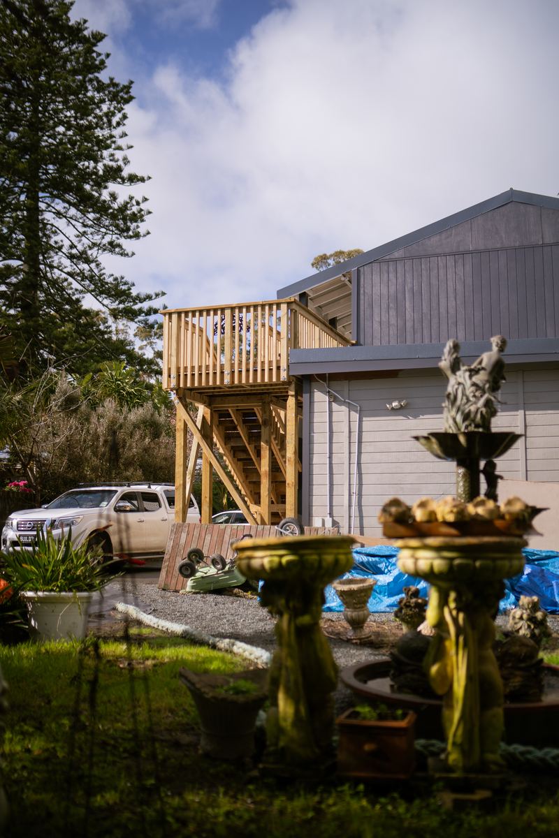 New deck and entry stairs above a garden