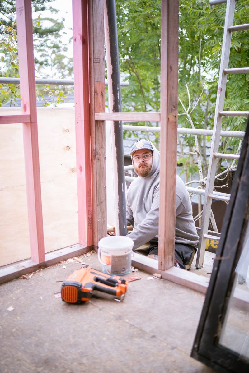 Builder fixing new framing on an upstairs extension
